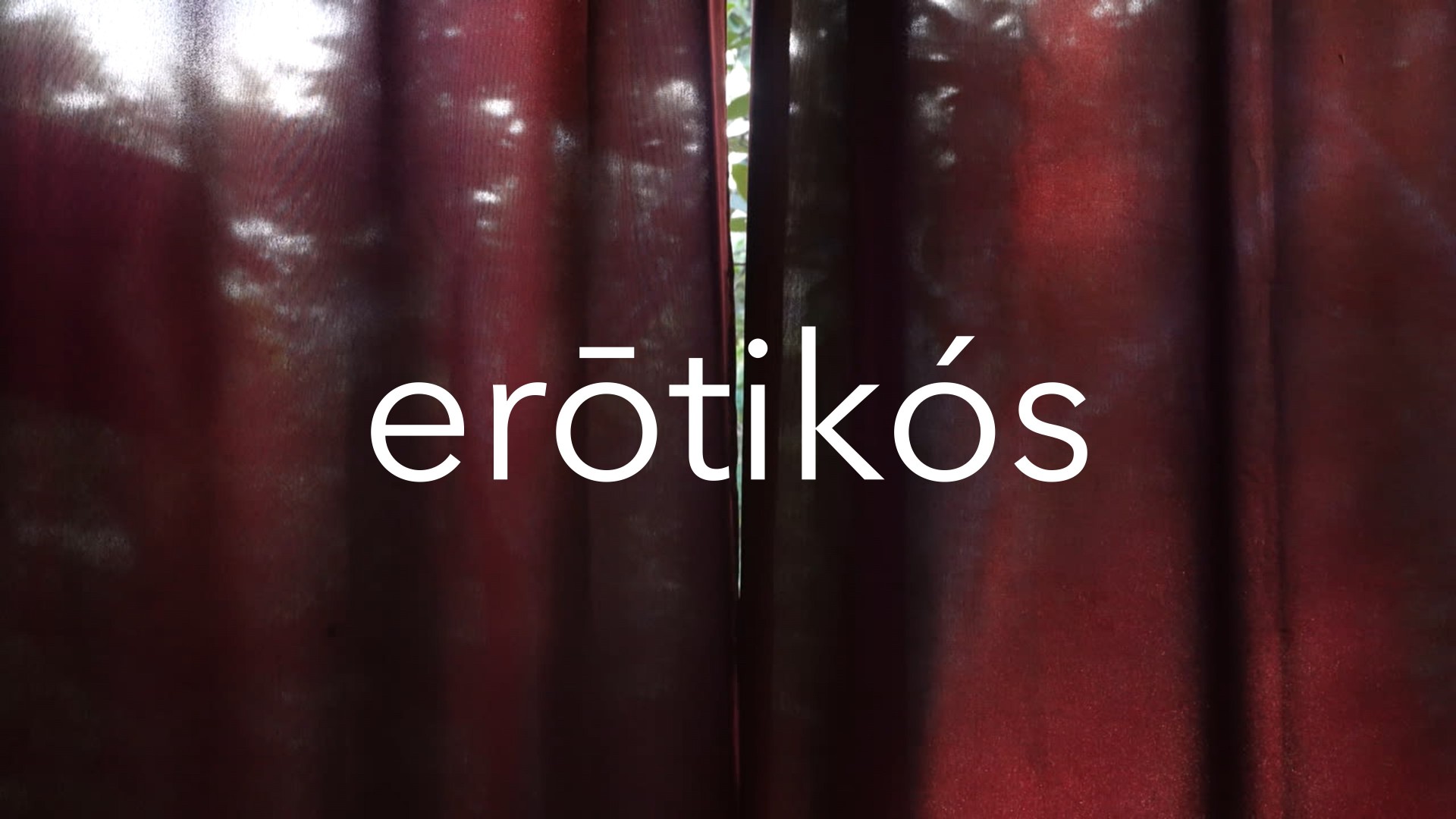 Red curtain with the text erōtikós